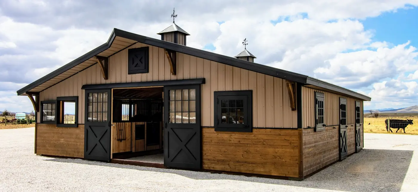 34×36 two-piece horse barn with two cupolas and horse weathervanes, open ground